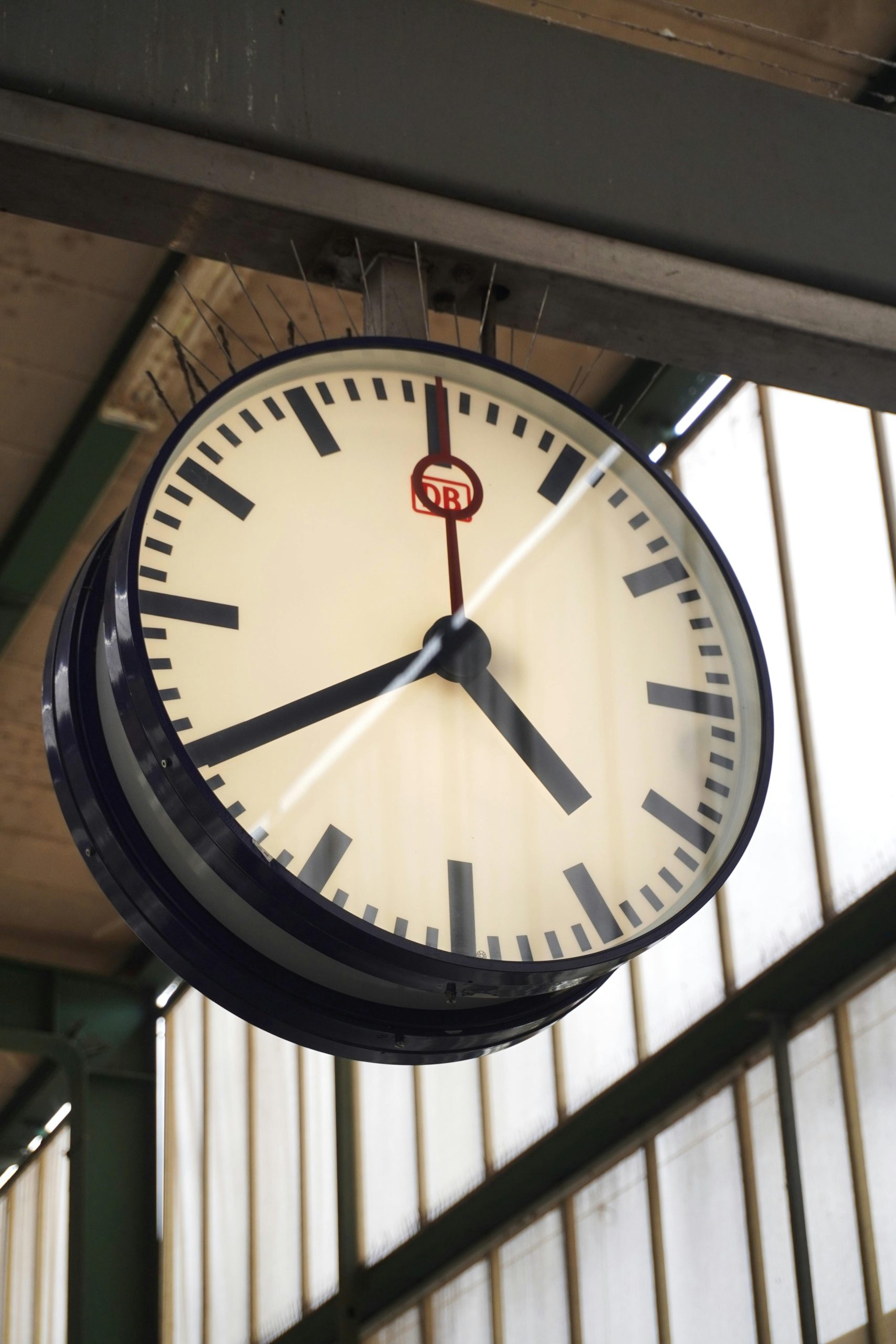 Vintage clock at Stuttgart train station, highlighting German engineering.